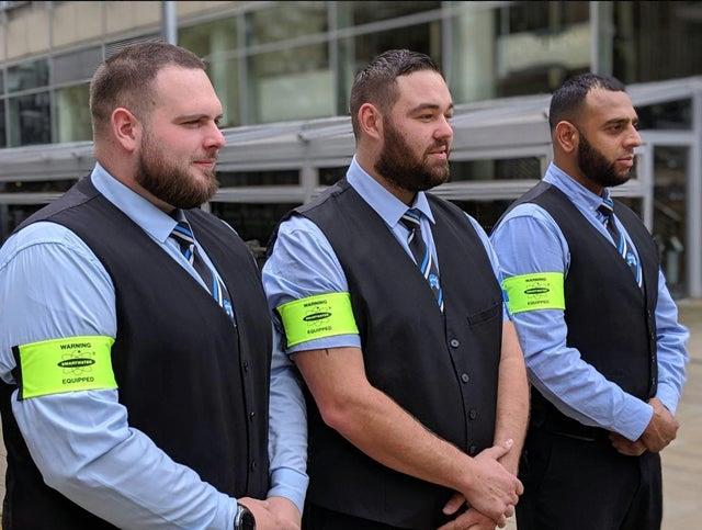 Security staff in high-visibility vests